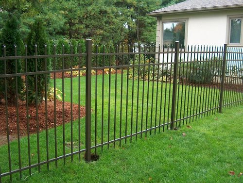 Bronze aluminum fence installed along a landscaped yard in Anderson County, SC