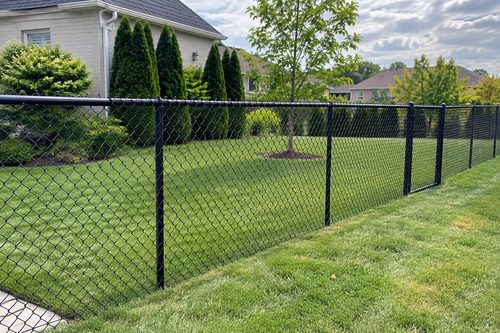 Fence replacement in Easley, SC with new galvanized chain link replacing a rusted fifty year old run